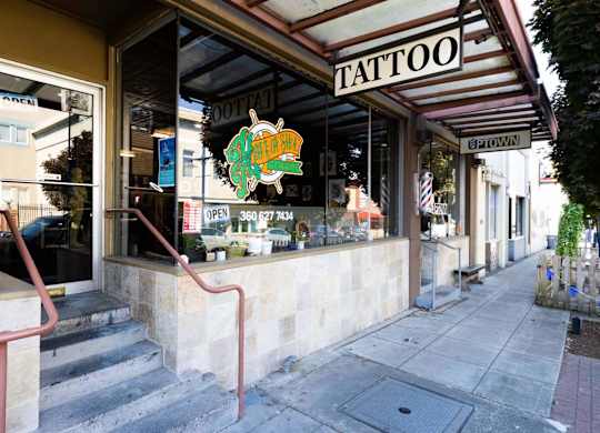 A tattoo shop with a sign that says