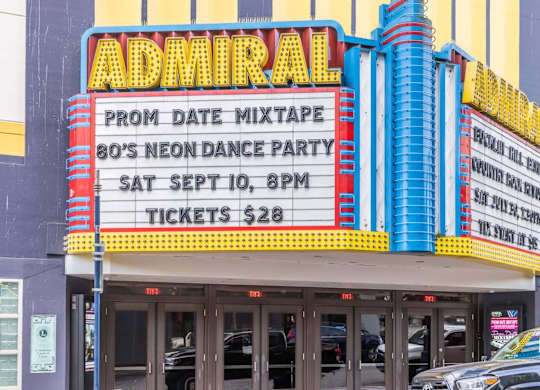 A sign for an 80's Neon Dance Party at the Admiral movie theatre.