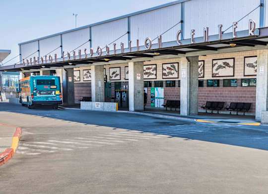 A bus is parked at a bus stop with a sign that says