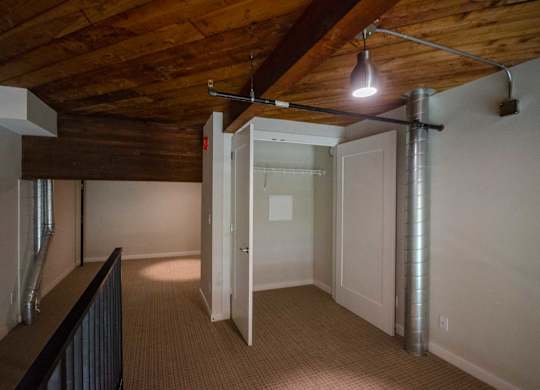 A room with a wooden ceiling and a white door at B Flats Apartments, Bremerton, WA