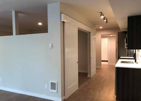 A kitchen area with a sink and a counter at B Flats Apartments, Bremerton