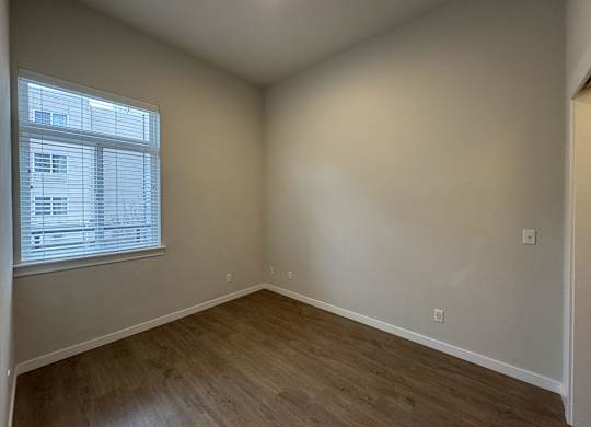 Empty room with wooden flooring and a window. at B Flats Apartments, Washington 98337