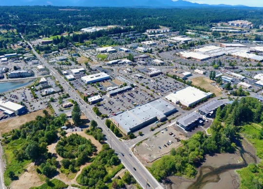 an aerial view of a city with a river in the background at Rivulet, Silverdale, 98383