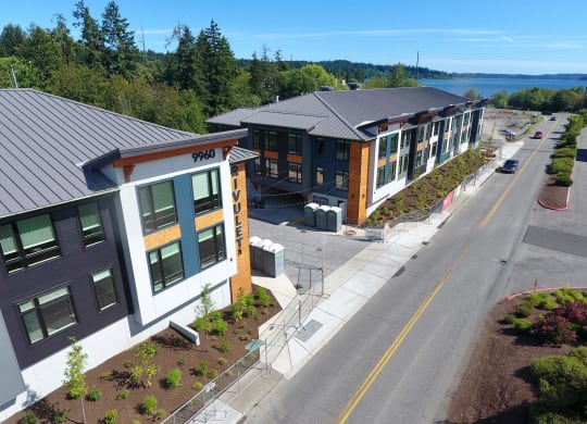 an aerial view of a building with a lake in the background at Rivulet, Silverdale, 98383