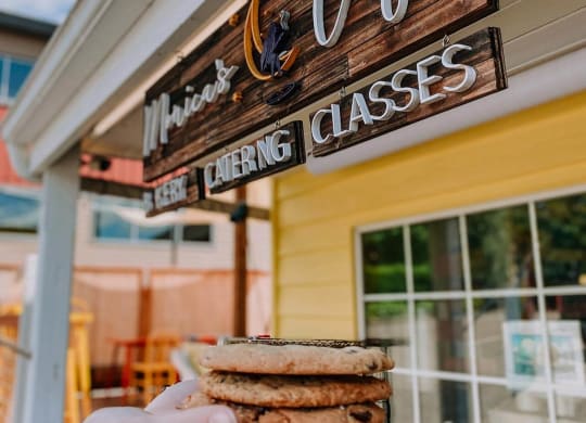 a hand holding a sandwich in front of a building at Rivulet, Silverdale, 98383
