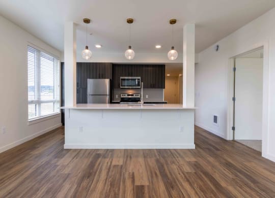 a kitchen and living room with a white counter top and at Rivulet, Silverdale, WA