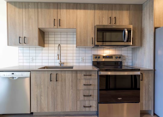 a kitchen with wooden cabinets and a stove and a microwave at Rivulet, Silverdale Washington