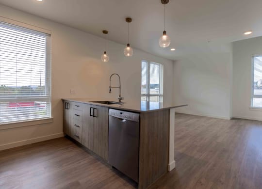 an empty kitchen with a large island in the middle at Rivulet, Silverdale Washington