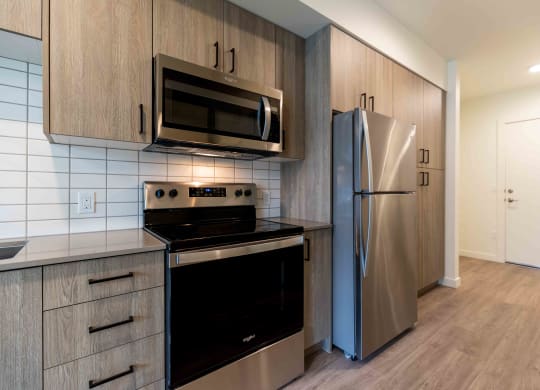 a kitchen with stainless steel appliances and a refrigerator at Rivulet, Washington, 98383
