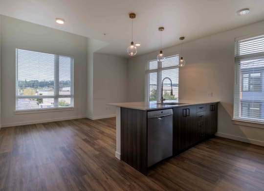an empty kitchen with a large window and a counter top at Rivulet, Silverdale