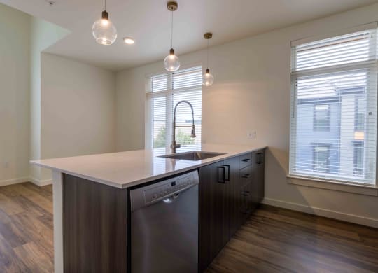 a kitchen with a large island and two windows  at Rivulet, Silverdale, WA, 98383