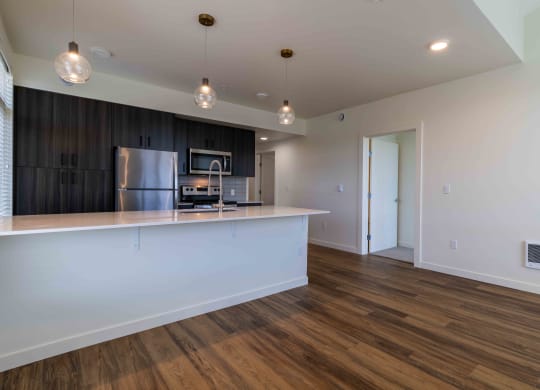 a kitchen with a large island and a stainless steel refrigerator at Rivulet, Silverdale, WA