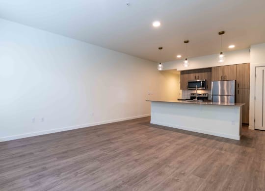 an empty living room with a kitchen and a counter top at Rivulet, Washington