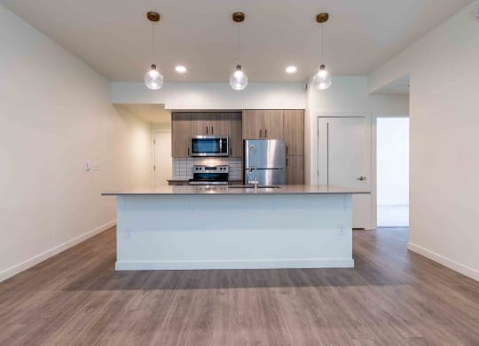 a large kitchen with a counter top and a refrigerator at Rivulet, Silverdale, 98383