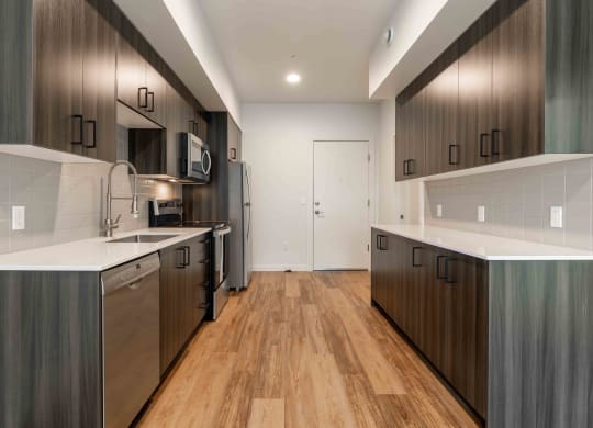 a renovated kitchen with wooden floors and stainless steel appliances at Rivulet, Silverdale
