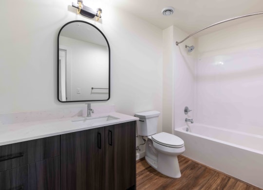 a bathroom with a toilet sink and a mirror at Rivulet, Silverdale Washington