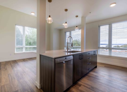 an empty kitchen with a large window and a sink at Rivulet, Silverdale