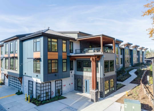 a building with many windows and a sidewalk at Rivulet, Silverdale, 98383