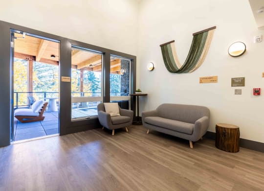 a living room with couches and chairs and a door to a balcony at Rivulet, Silverdale Washington