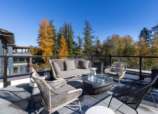 a patio with chairs and a glass table on a balcony at Rivulet, Silverdale