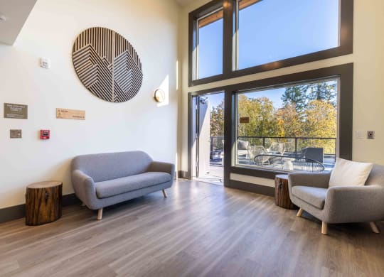 a living room with two couches and a large window at Rivulet, Washington