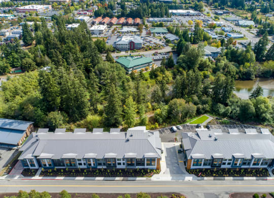 an aerial view of a building surrounded by trees and a river at Rivulet, Silverdale, 98383