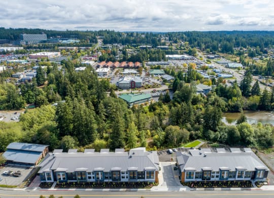 an aerial view of a city with trees and buildings at Rivulet, Silverdale, WA