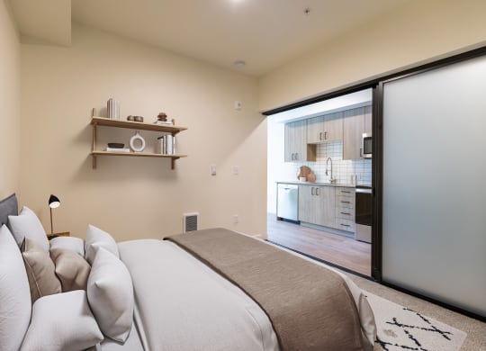 a bedroom with a bed and a sliding glass door to a kitchen at Rivulet, Silverdale, 98383
