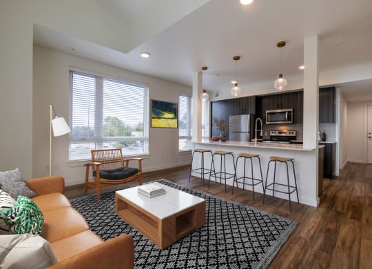 a living room with a kitchen with a bar and a couch at Rivulet, Silverdale, WA