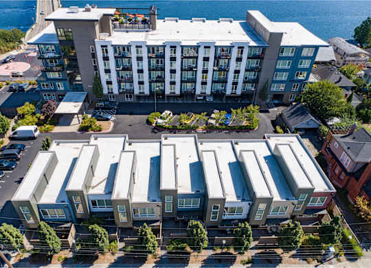 an aerial view of an apartment complex with a body of water in the background at Spyglass Hill Apartments, Bremerton, Washington
