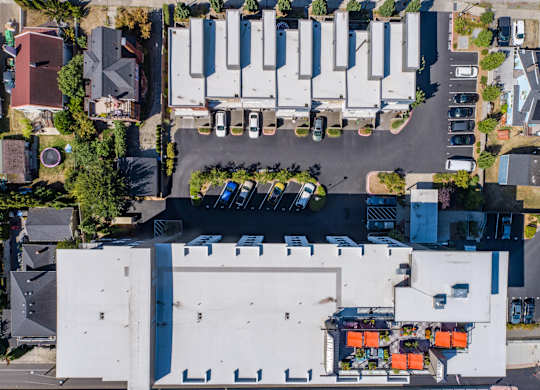 an aerial view of a parking lot with cars parked on top of a building at Spyglass Hill Apartments, Bremerton