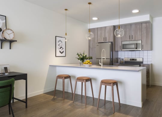 a kitchen with a large center island next to a stove top oven at Rivulet, Washington