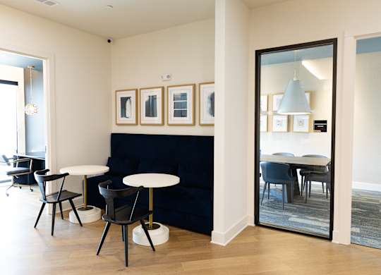 Contemporary cafe seating area with framed artwork at The Crest at South Point Apartments, Georgia, 30253