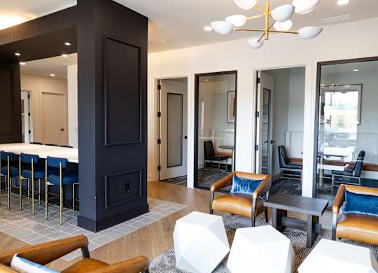Resident lounge with private meeting rooms and seating areas at The Crest at South Point Apartments, McDonough