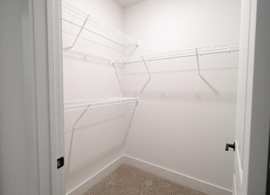 Walk-in closet with white wire shelving at The Crest at South Point Apartments, McDonough