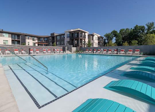 Resort style swimming pool with lounge chairs and lap lanes at The Wren Apartments, Lawrenceville, 30043