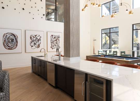 Clubhouse kitchen with pool table and high ceilings at The Wren Apartments, Georgia, 30043