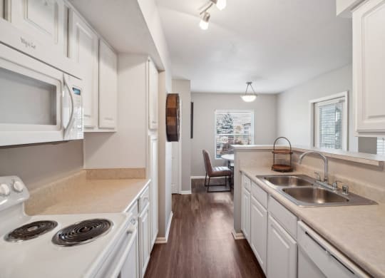 spacious kitchen with white cabinets at Dakota Ridge apartments