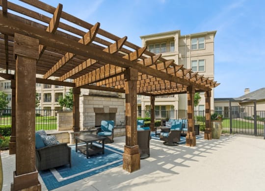 outdoor pergola patio with fireside lounging area at Retreat at Wylie senior 55+ apartments
