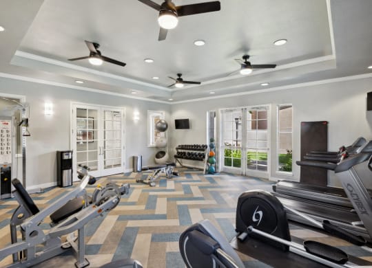 fitness center with cardio equipment and free weights at Bridgeport Ranch apartments