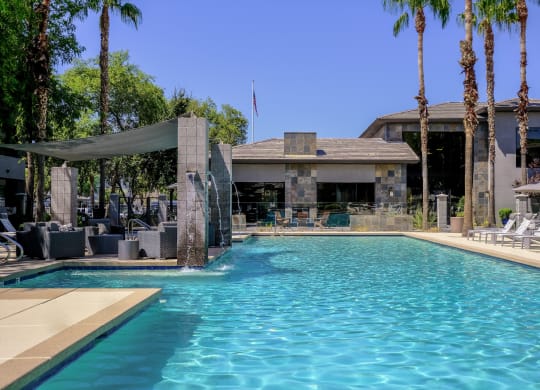 swimming pool with resort-inspired lounge seating at Avora luxury apartments