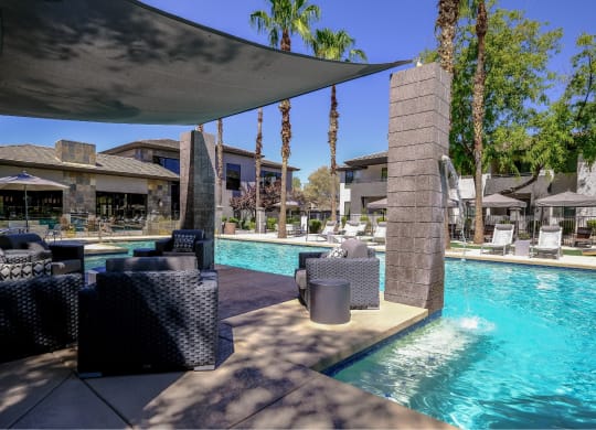 resort-inspired, covered lounging area and swimming pool at Avora apartments