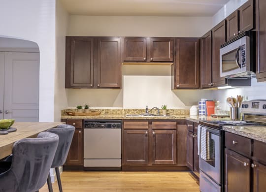 luxury kitchen with granite countertops and custom cabinetry at The Pradera apartments