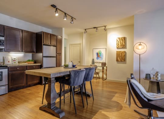 spacious open concept kitchen and living area with hardwood inspired flooring at The Pradera apartments