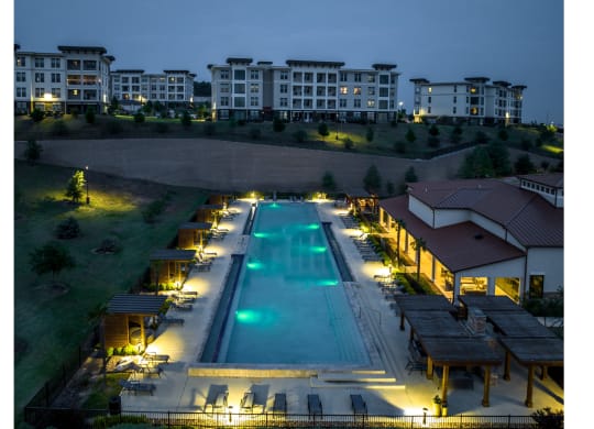 evening view of the swimming pool at Reveal Skyline apartments