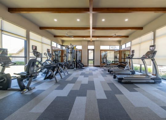 fitness center with cardio equipment at The Pradera apartments