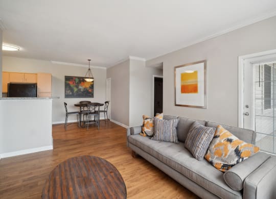 living room with wood-inspired flooring at Red Hawk Ranch apartments