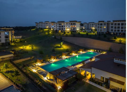 evening view of the resort-inspired swimming pool at Reveal Skyline apartments