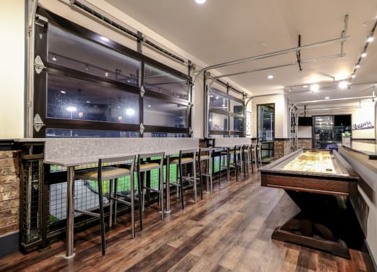a game room with a pool table and a bar