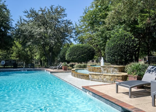 luxury swimming pool with a fountain at Stoneleigh on Spring Creek apartments